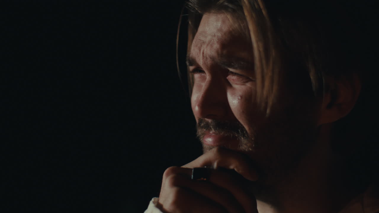 Close-up of a Man Crying in Darkness