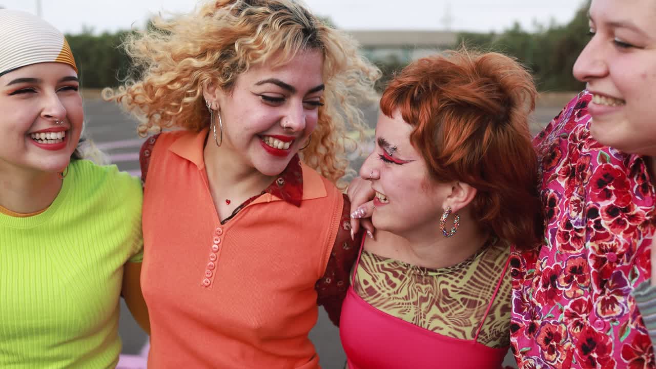 Young diverse female friends having fun outdoor laughing together