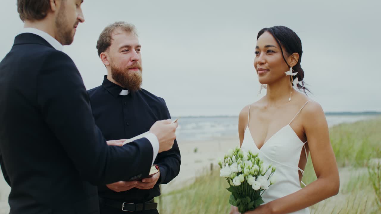 Beach Wedding Ceremony with Bride, Groom, and Minister