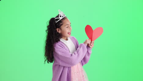girl with crown holding a heart on green background