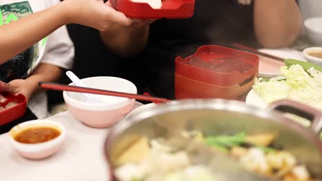 friends sharing a hotpot meal together