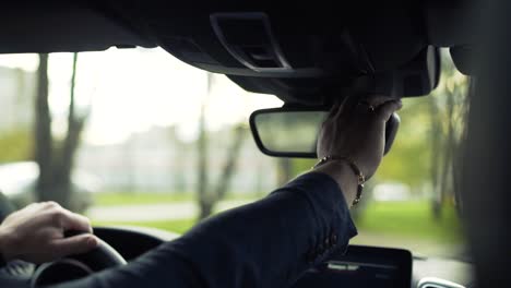 adjusting rearview mirror while driving