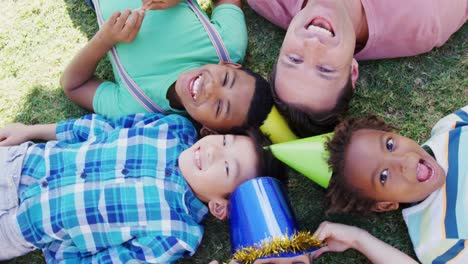 man with kids lying on field 4k