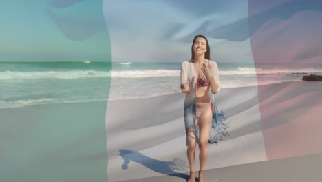animation of flag of italy over caucasian woman at beach