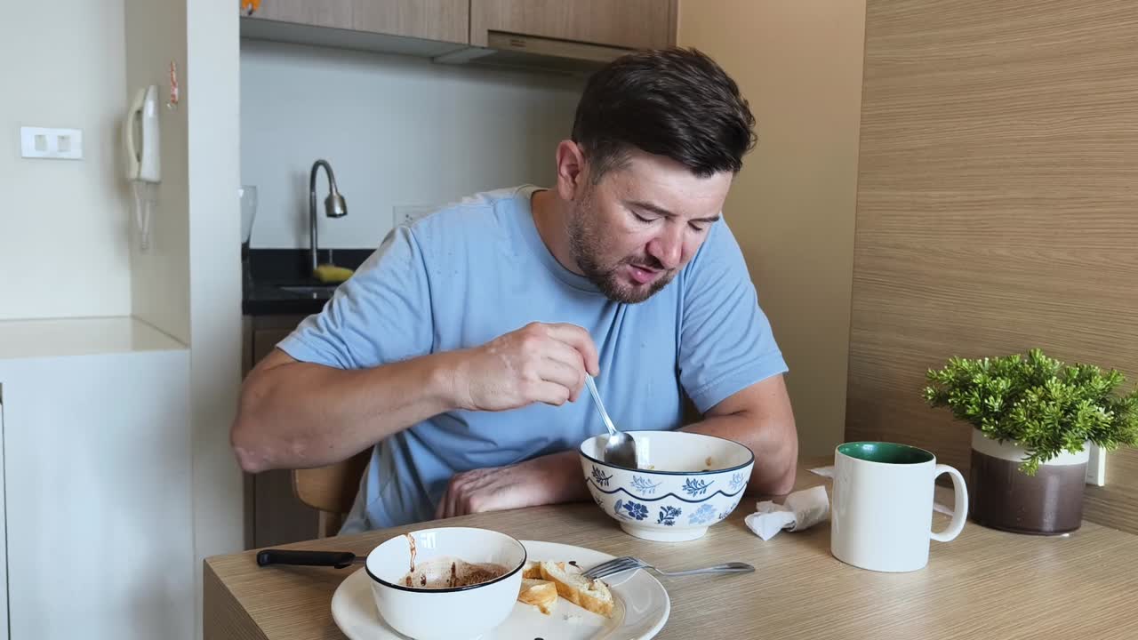 Man Eating Breakfast at Table
