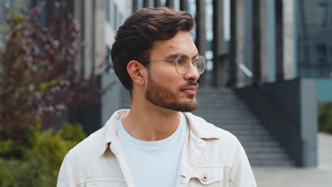 smiling man in a white shirt and glasses