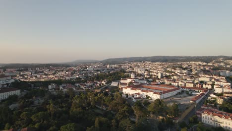 aerial flying towards coimbra prision establishment building, cityscape horizon