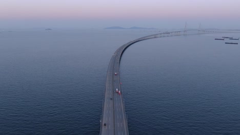 a long bridge over the sea at dawn