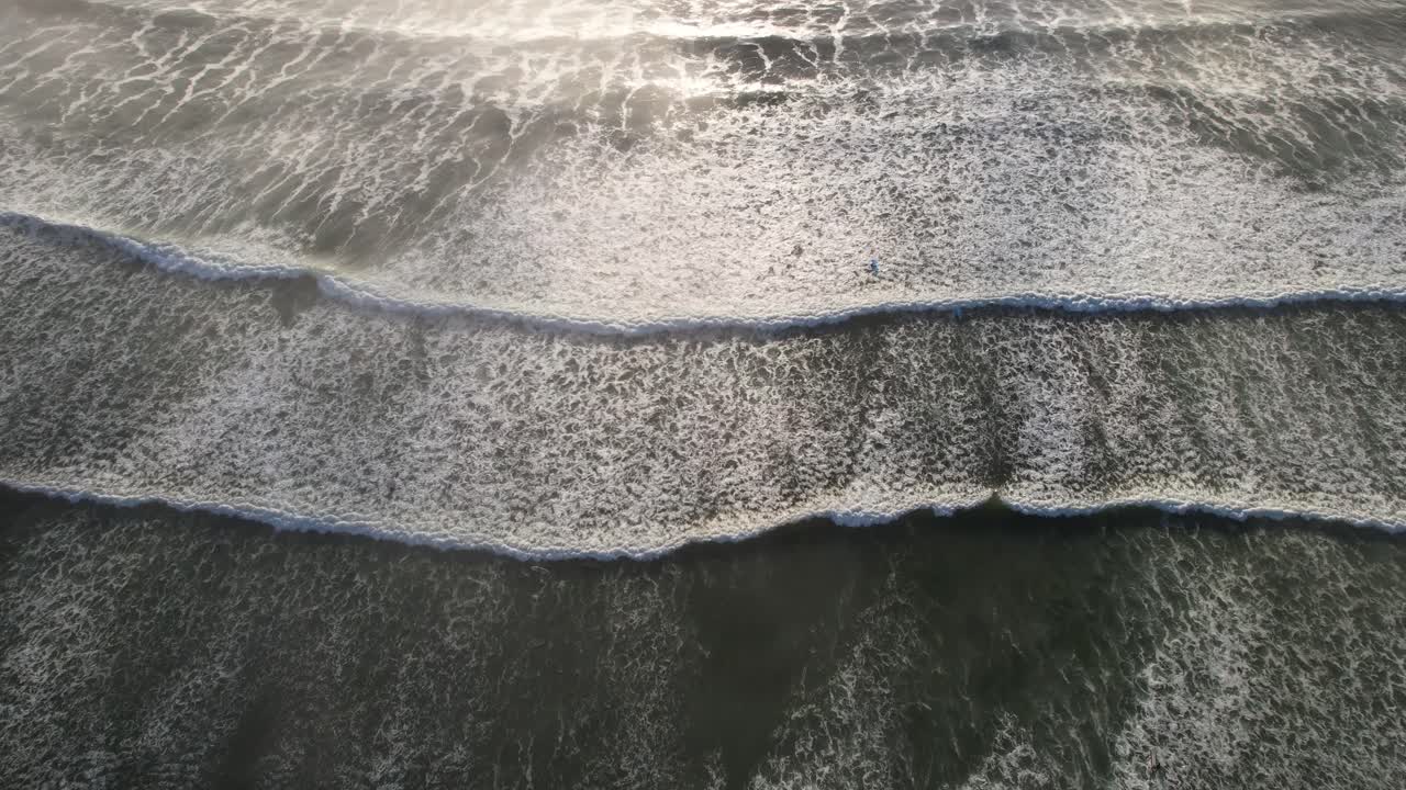 Waves slowly washing up on beach