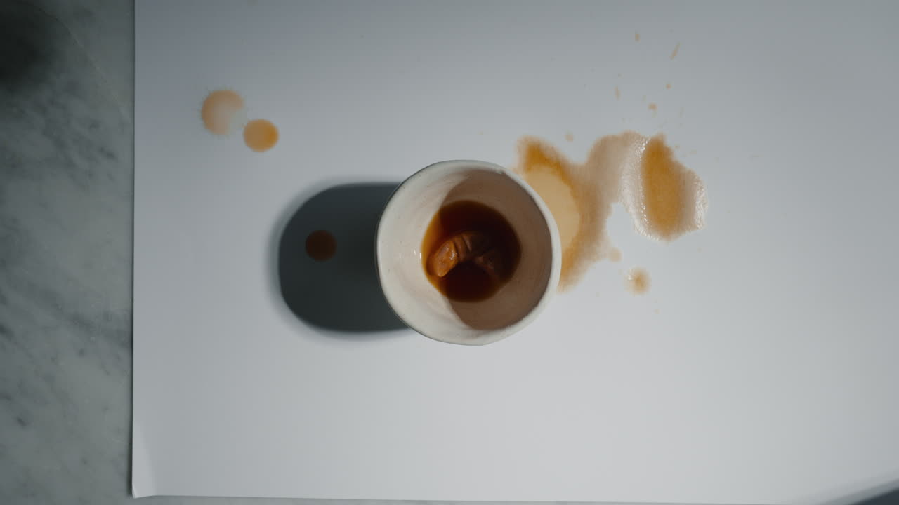 색 표면 에 흘린 커피 컵 의  뷰