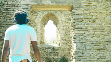 4k footage of black man walking through the ruins of st' peter's church