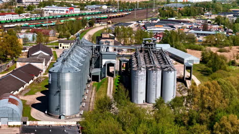 industrial modern grain crop silo storage facility building facility, aerial drone view