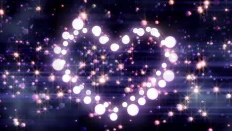 animación en forma de corazón de esferas blancas brillantes con esferas de color que se elevan sobre un fondo oscuro