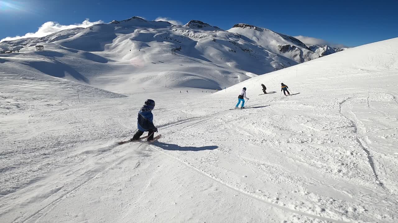 Kids learning how to ski with the ski instructor in the mountains