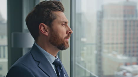 rich ceo drinking coffee watching cityscape at big window closeup. boss relaxing