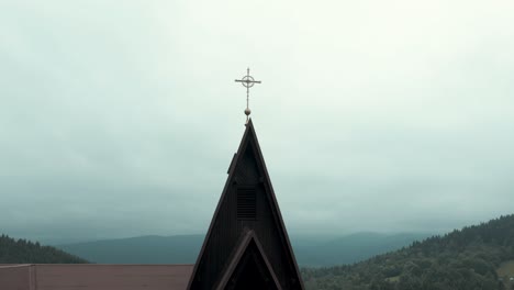 church cross on top of the old wooden church