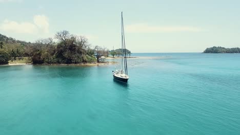 drone footage of a sail boat at one of panama's islands "playa blanca" located at colon province.