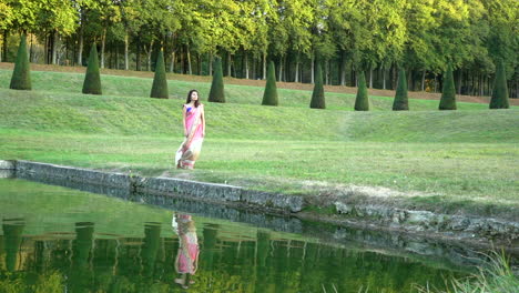 girl with indian dress walking around a lake