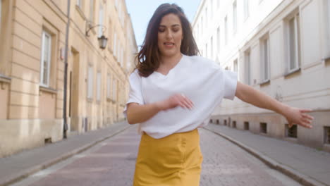 beautiful woman dancing latin dance alone in the old town street 3