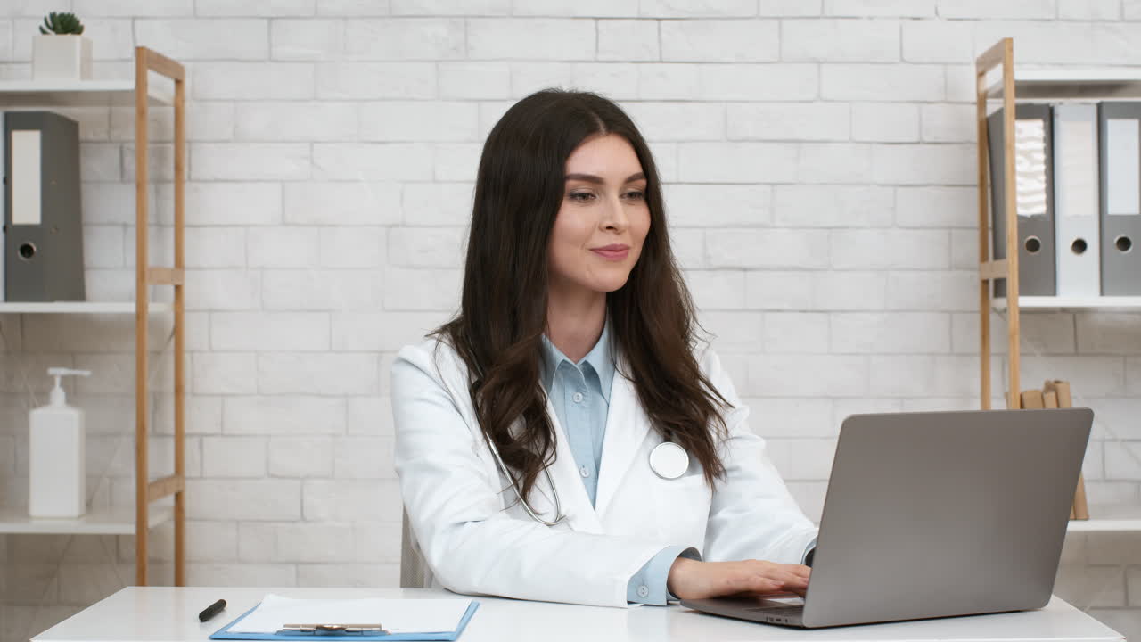 Female Doctor Working on Laptop in Office