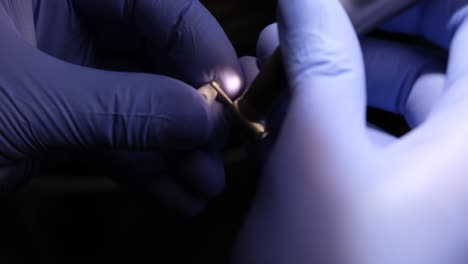 Close-up of hands in medical gloves performing precision work with instruments