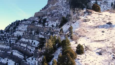 awesome backwards aerial view of provo´s canyon mountains covered in snow