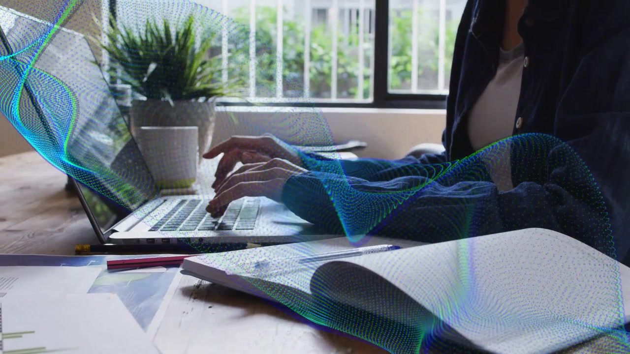 Woman typing triggers blue-green wave graphic sweeping over laptop, hands, notebook for study