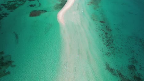 aerial view of a tropical island with turquoise water and white sand beaches