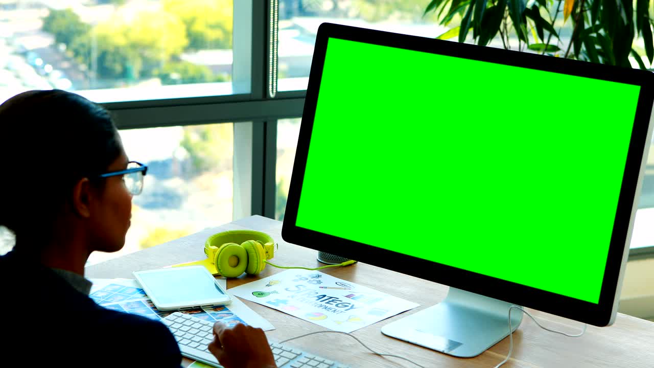 Female graphic designer working over computer at her desk