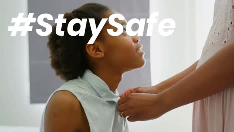 animation of stay safe text over mother and daughter at home