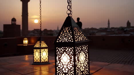 Ornate lanterns at sunset with cityscape
