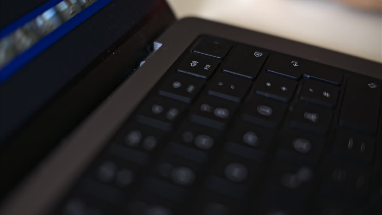 Close up black notebook keyboard with illuminated buttons