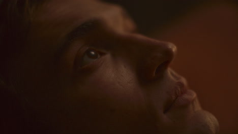 close up of young contemplative man gazing upward