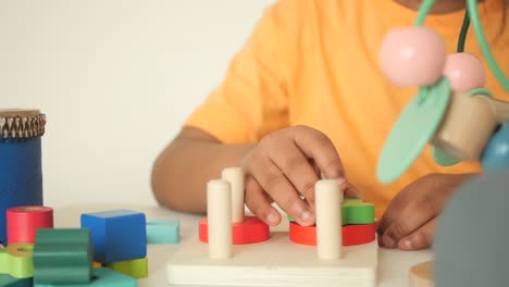 child playing with wooden puzzles and blocks