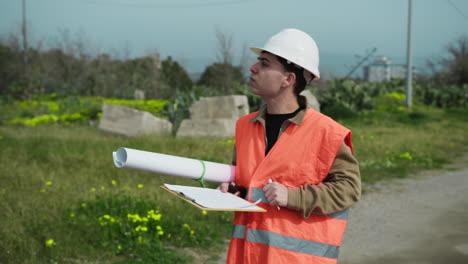 architect taking notes while walking on the construction site and looking around