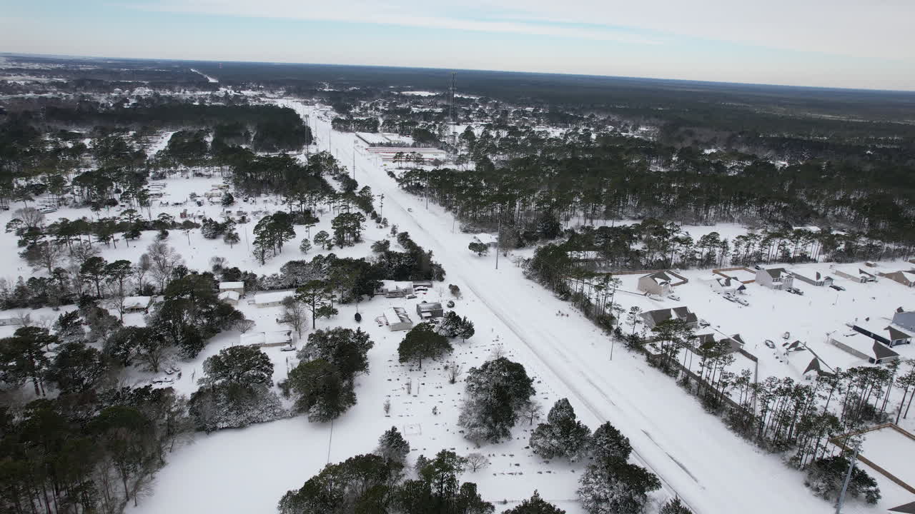 Aerial shot of coastal North Carolina after a large snow storm. Snow covered road