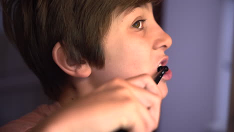 close up portrait young caucasian boy brushing his teeth health