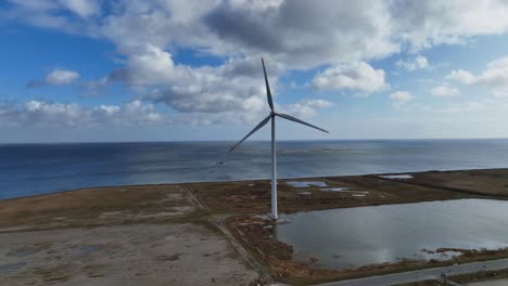 an aerial view an electric windmill with a wind turbine and rotating blades is an ecological energy source