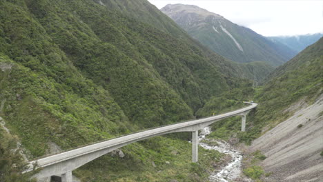 truck driving over the otira viaduct bridge in arthurs pass new zealand