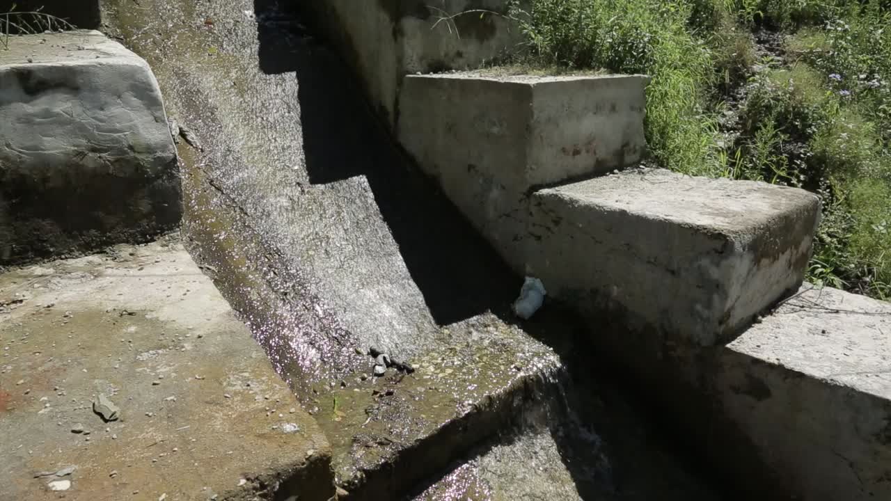 Water Flowing Through a Stone and Concrete Canal
