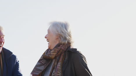 Loving-Active-Senior-Couple-Walking-Hand-In-Hand-Through-Countryside-Together