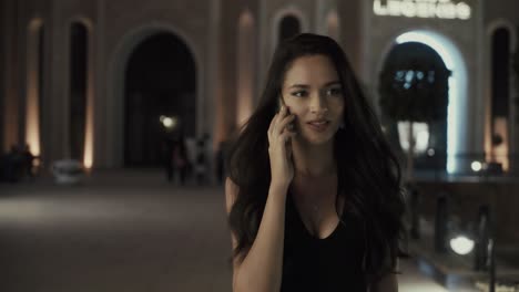 woman talking on phone at night