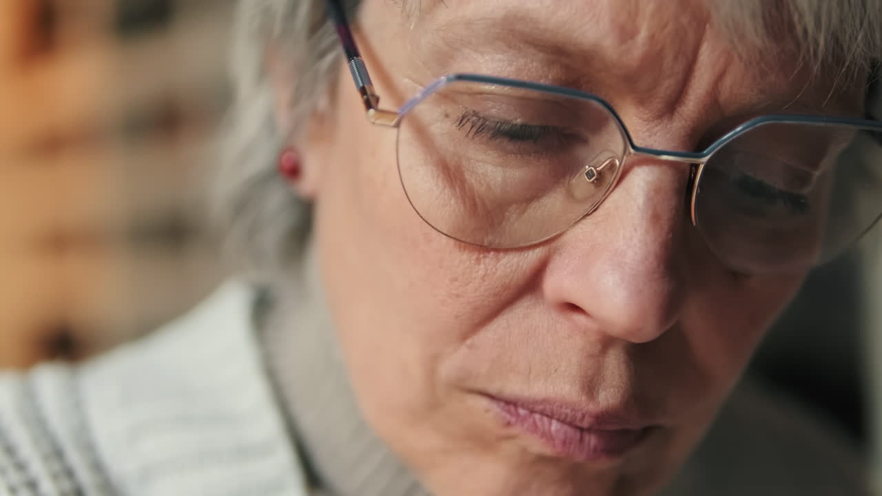 Close-up of a Focused Senior Woman Wearing Glasses
