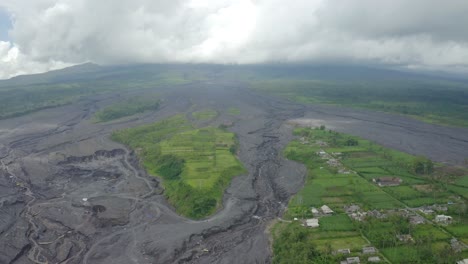 aerial view of the black rock and sandy flow destruction at the base of volcano, semeru, east java indonesia