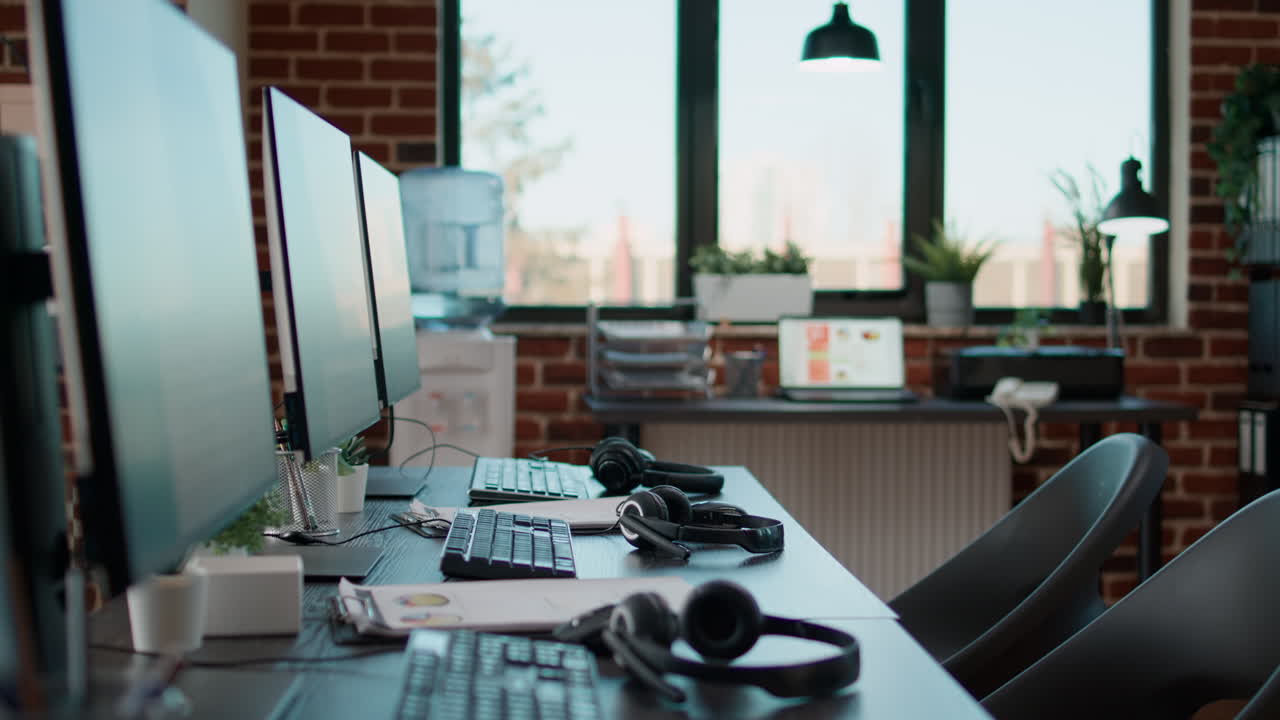 No people at desk with multiple computers in call center office