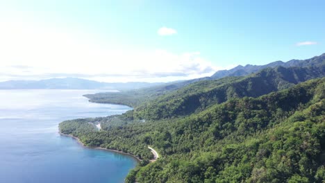 aerial view of green mountains with ocean view at summer in tropical island of philippines