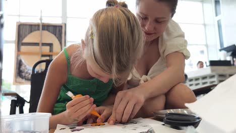 mother and daughter decorating cookies