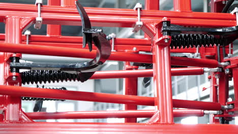 Ready-agricultural-machinery-in-red-color.-New-equipment-for-agriculture