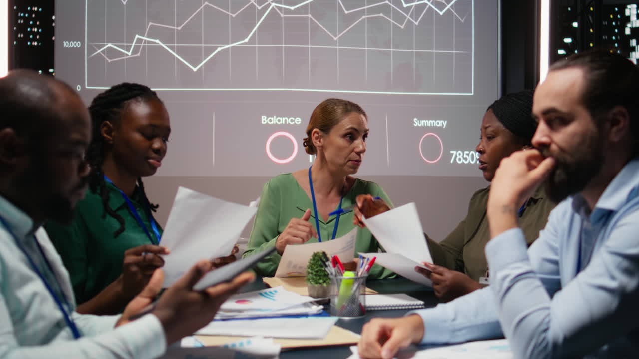 Close up of diverse business team meeting after hours for visual data reports