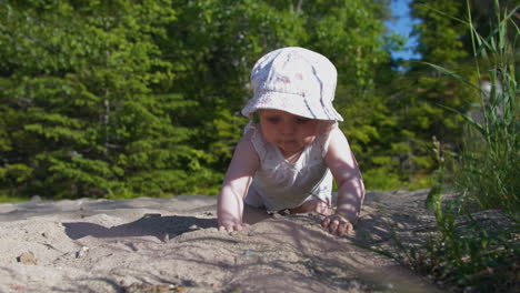 Curious-Baby-girl-playing-in-sand